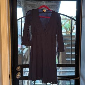 Deep V fit and flare navy dress with small grommet accents.